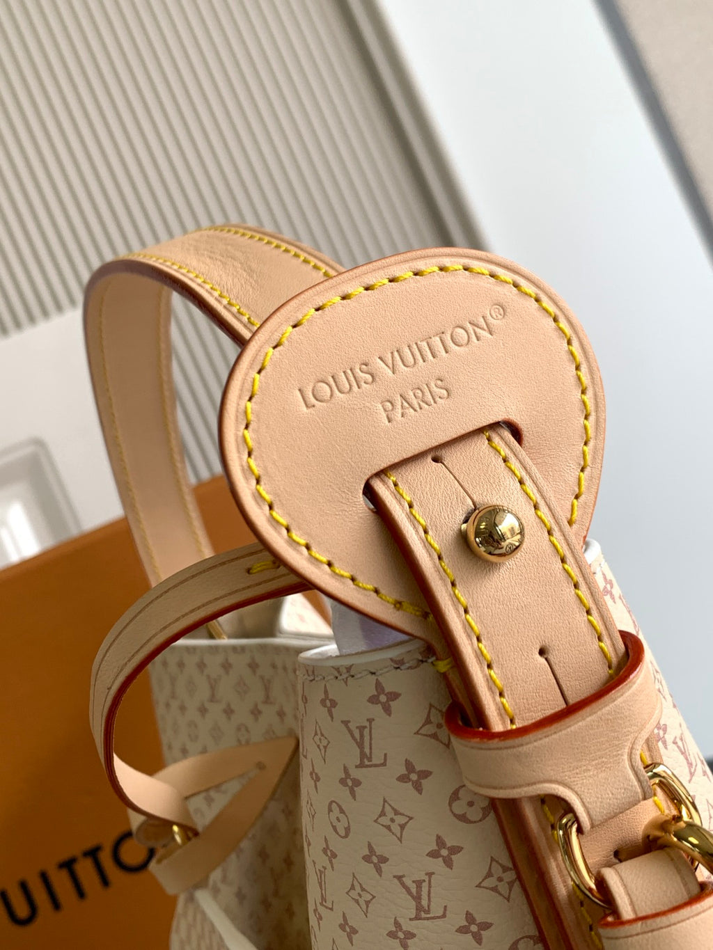 Louis Vuitton small bag with tan monogram canvas, studded clasp and leather trim