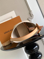 Louis Vuitton small shoulder bag with open top, beige interior and tan leather strap
