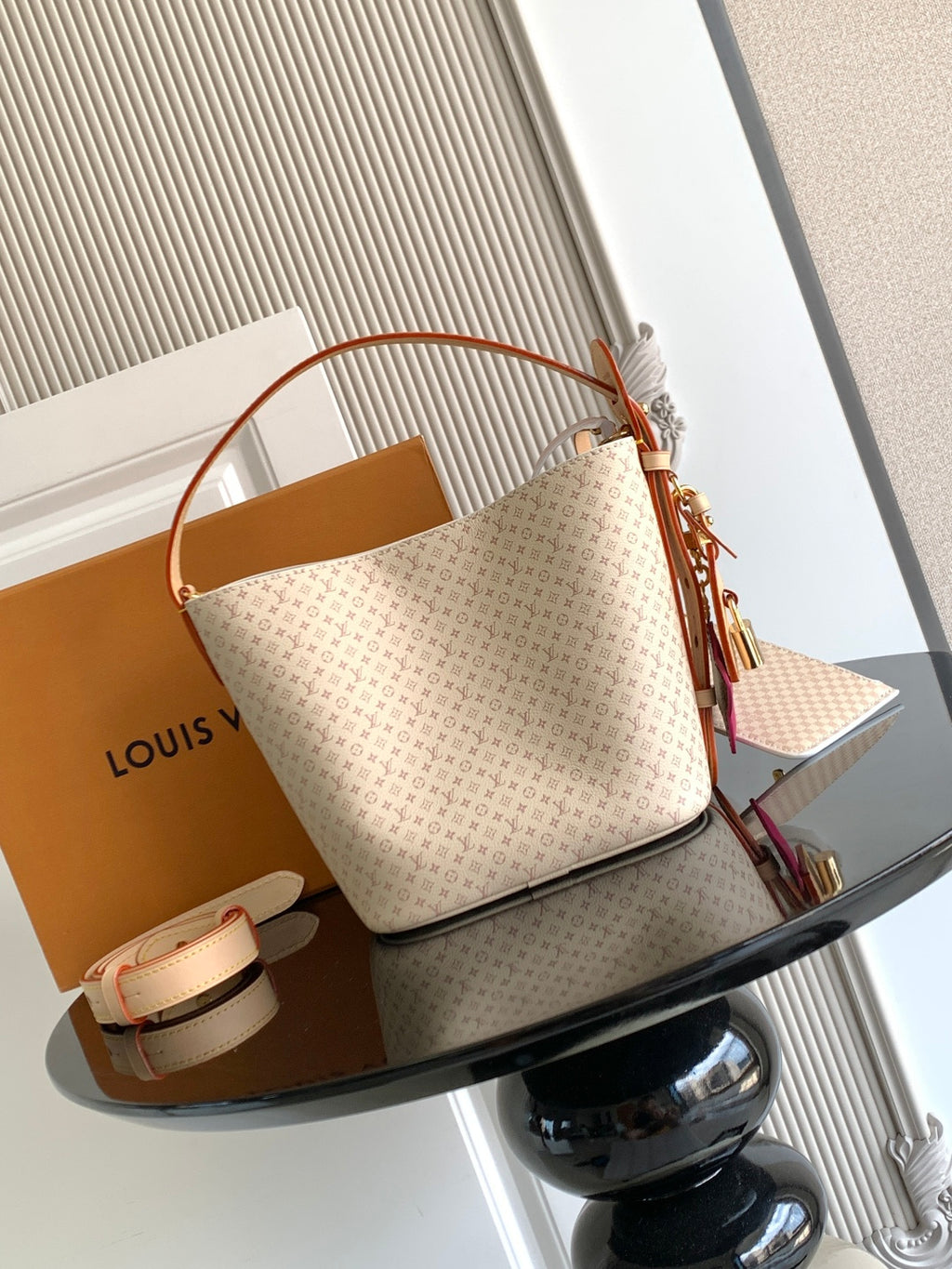 Louis Vuitton shoulder bag with tan monogram canvas, curved leather handles and tassel