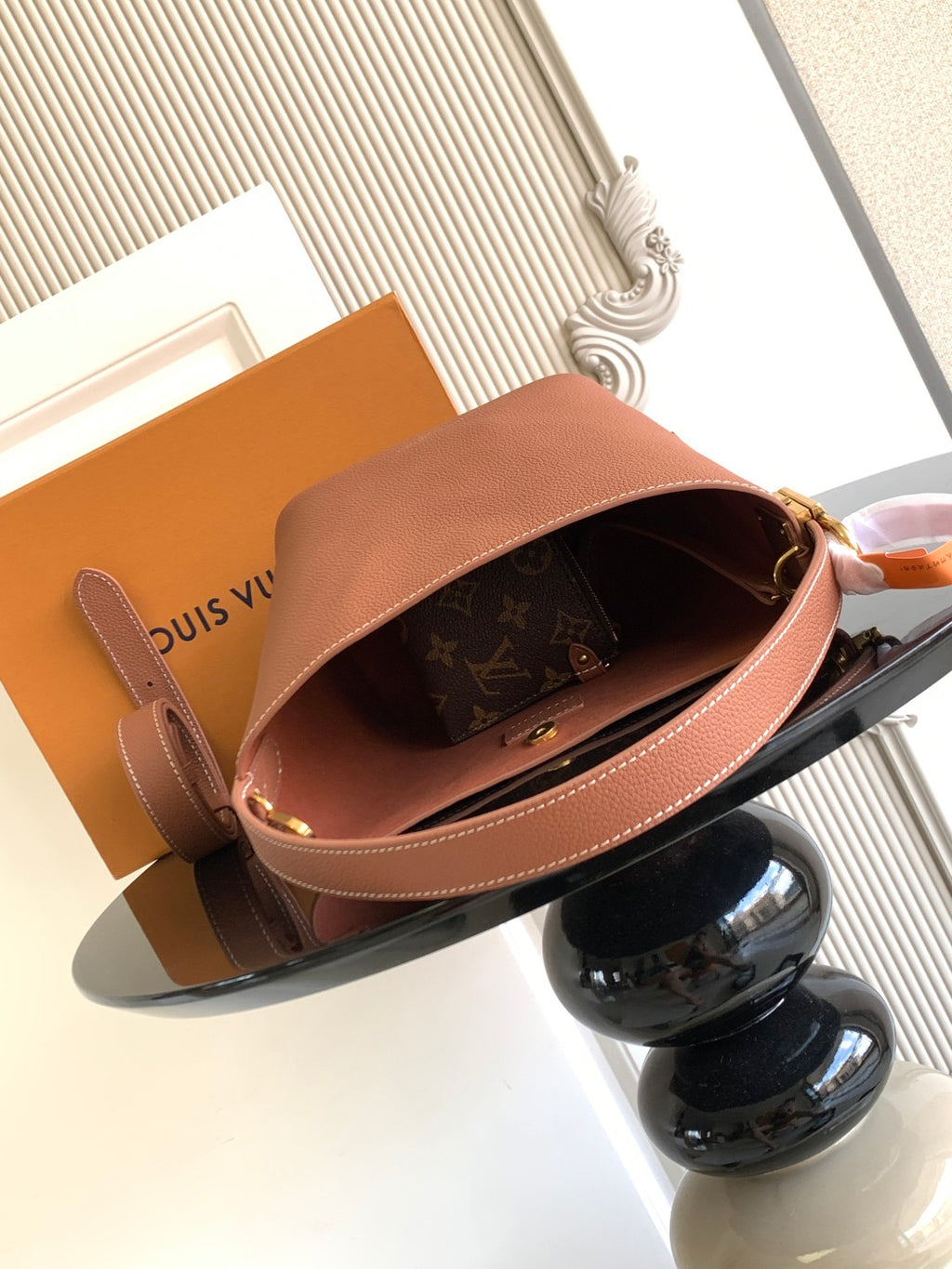 Louis Vuitton open-top bucket tote in pink leather showing brown interior