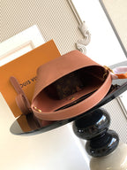 Louis Vuitton open-top bucket tote in pink leather showing brown interior