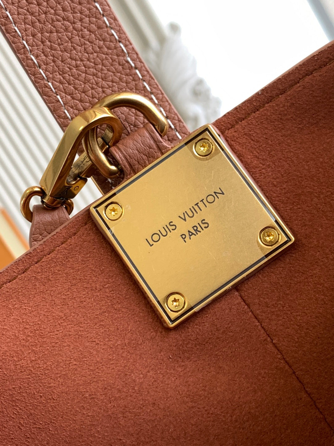 Louis Vuitton square gold clasp plate on pink leather bag with stitching detail
