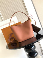 Louis Vuitton leather tote bag in pink with curved handles and side clasp