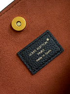 Brown leather bag detail with gold button and Louis Vuitton Paris label.