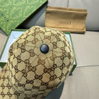 Gucci cap top view in brown GG monogram fabric with round dark button