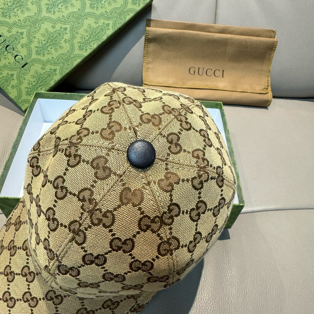Gucci cap top view in brown GG monogram fabric with round dark button