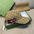 Gucci cap featuring brown GG canvas and a front stripe detail with yellow emblem