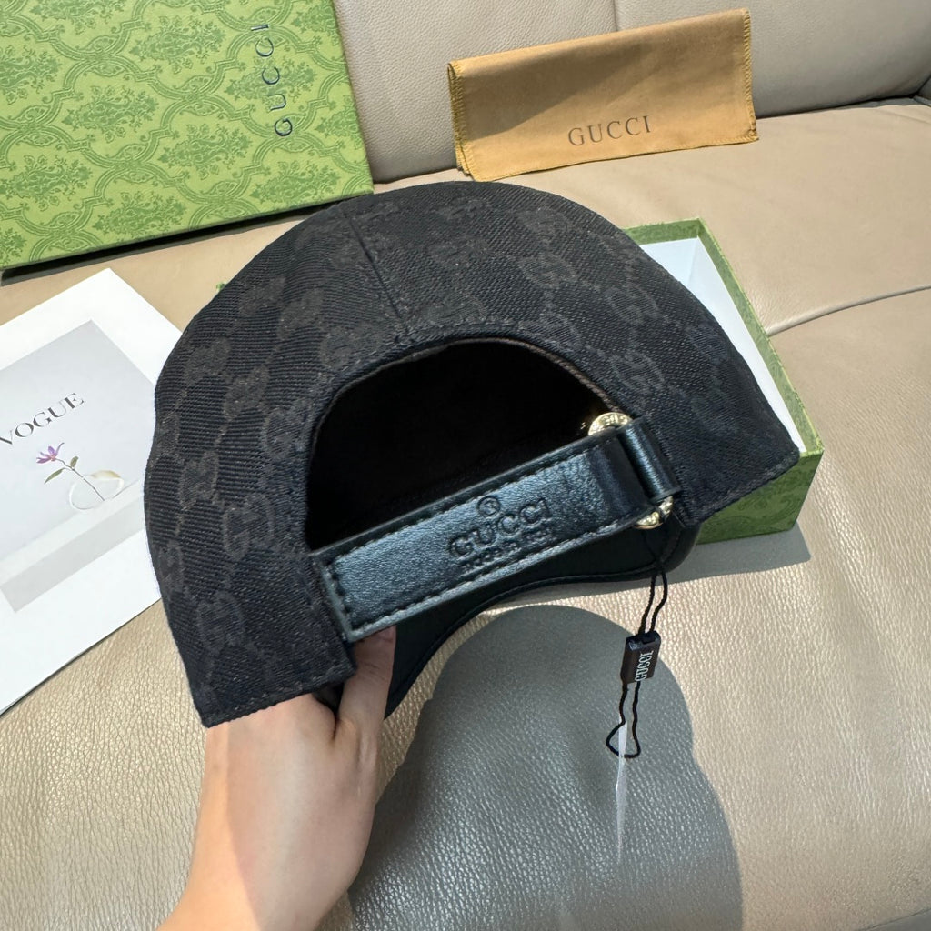 Black Gucci cap interior view with black strap and dangling tag at brim