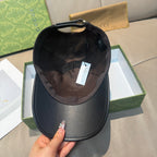 Black Gucci cap shown from inside with brown fabric lining and adjustable strap