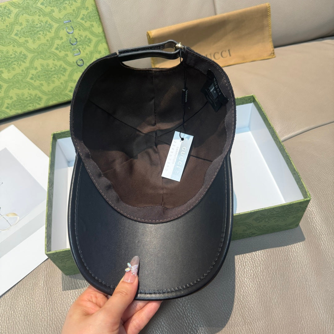 Black Gucci cap shown from inside with brown fabric lining and adjustable strap