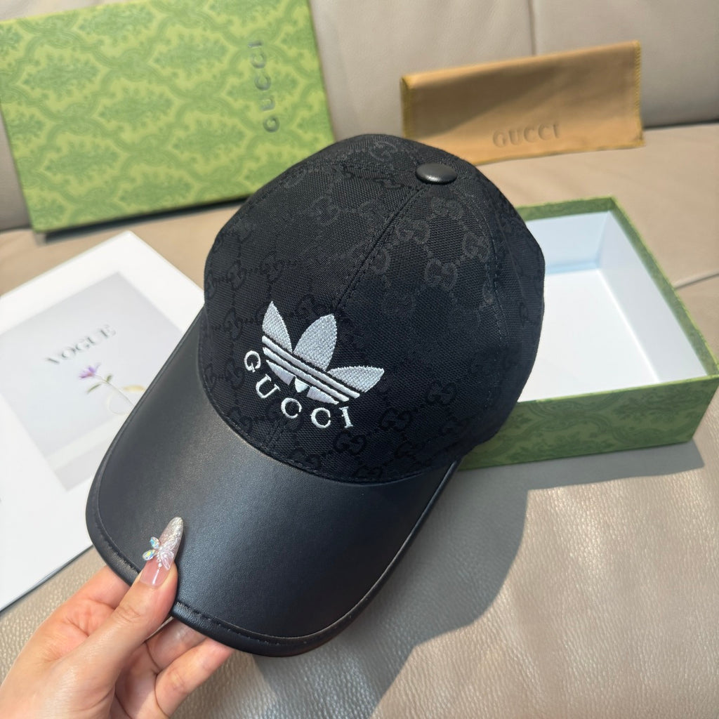 Black Gucci baseball cap with GG monogram pattern and white flower logo on front