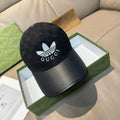 Black Gucci baseball cap with GG monogram and white logo on front, curved black brim
