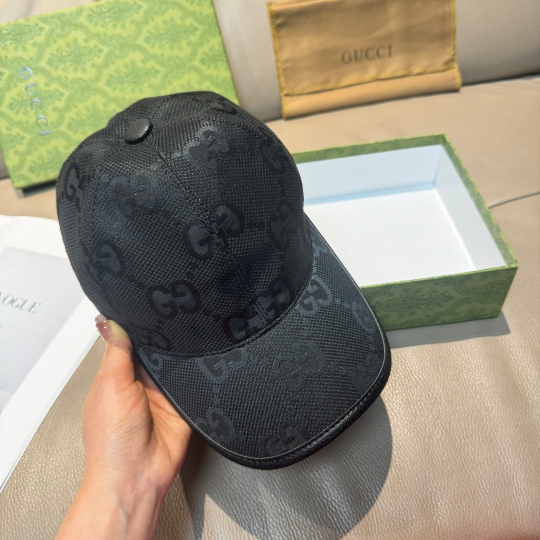 Black GG-print baseball cap, side view with curved brim and stitched seams.