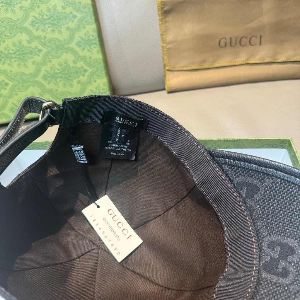 Black GG-print baseball cap with inner label and fabric strap, open interior view.