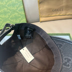 Black GG-print baseball cap with inner label and fabric strap, open interior view.