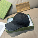 Black GG-print baseball cap with curved brim and logo pattern all over.