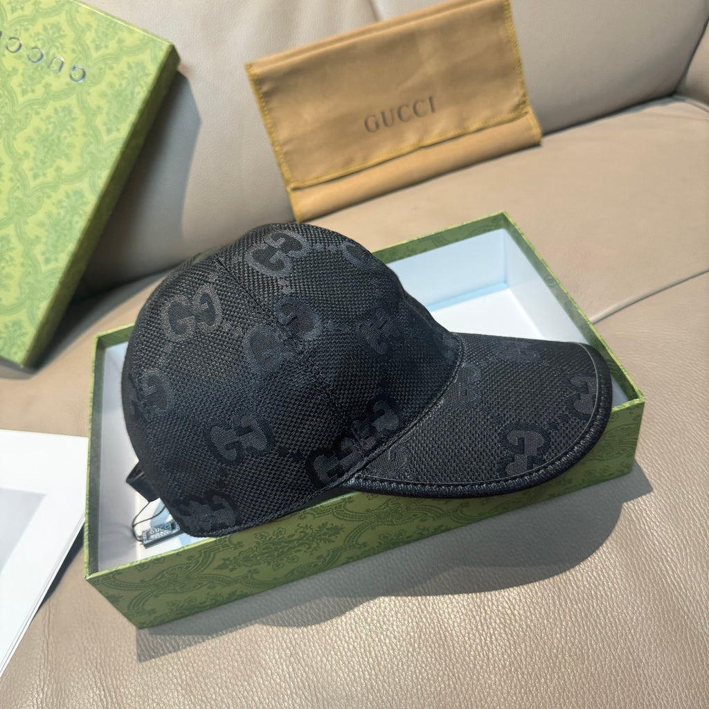 Black GG-print baseball cap with curved brim and front logo pattern.