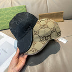 Pair of baseball caps: black and beige GG-print caps with curved brims.
