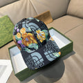Gucci baseball cap with black logo print and colorful floral panel front
