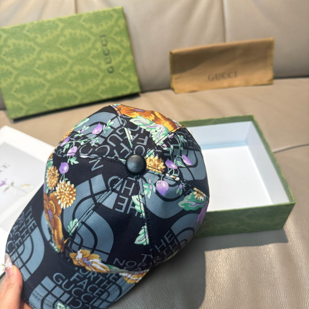 Gucci baseball cap with black crown and floral accents, round snap button