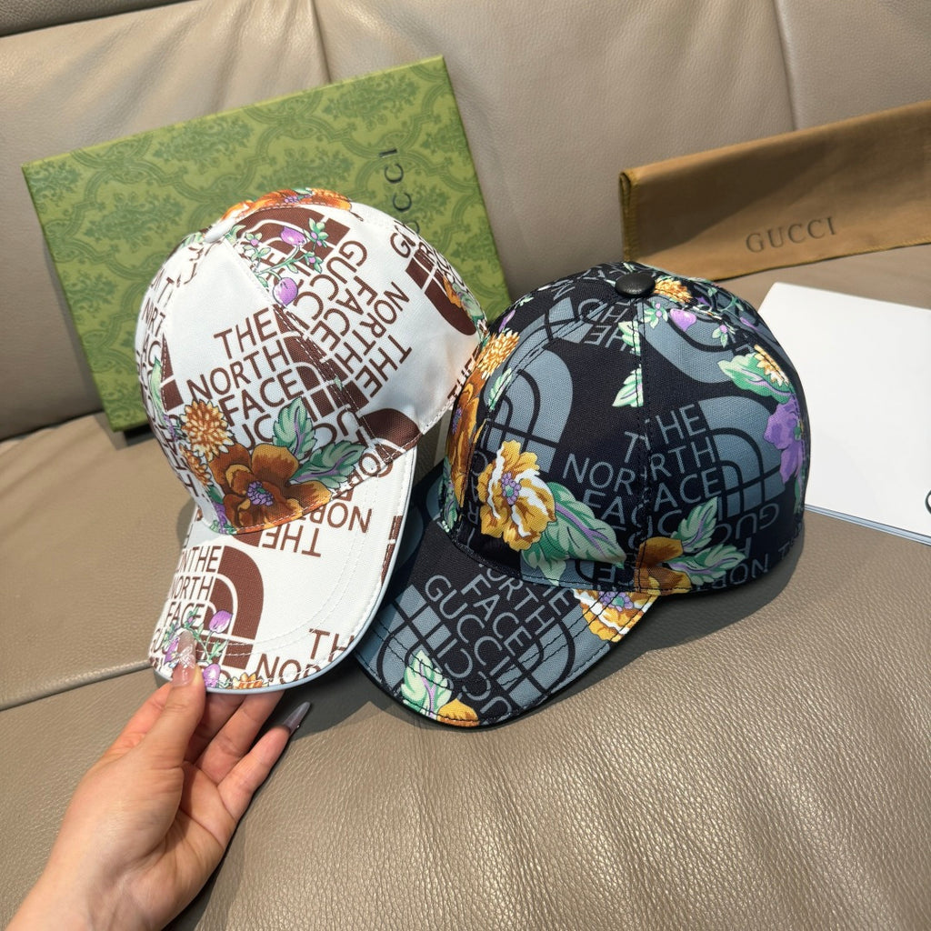 Gucci caps view, one white logo cap and one black floral logo cap