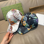 Gucci caps view, one white logo cap and one black floral logo cap