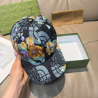 Gucci floral baseball cap front view, black crown with multicolor flower print