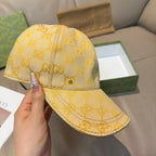 Yellow GG logo baseball cap shown in side view, curved brim