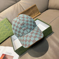 Gucci cap in light blue with red GG monogram pattern, curved brim and crown.