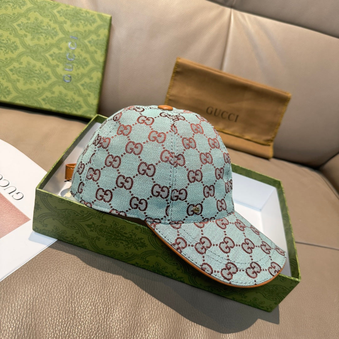 Gucci cap in light blue with red GG monogram pattern, front and side view.