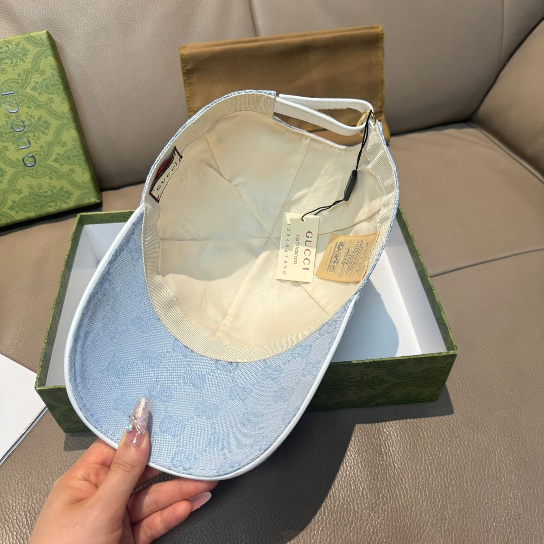 Gucci cap in light blue GG monogram with inside lining visible and adjustable strap.