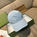 Gucci cap in light blue GG monogram denim-style with curved brim and stitched crown.
