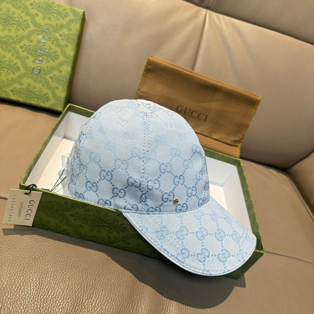 Gucci cap in light blue GG monogram pattern with curved brim and side view.