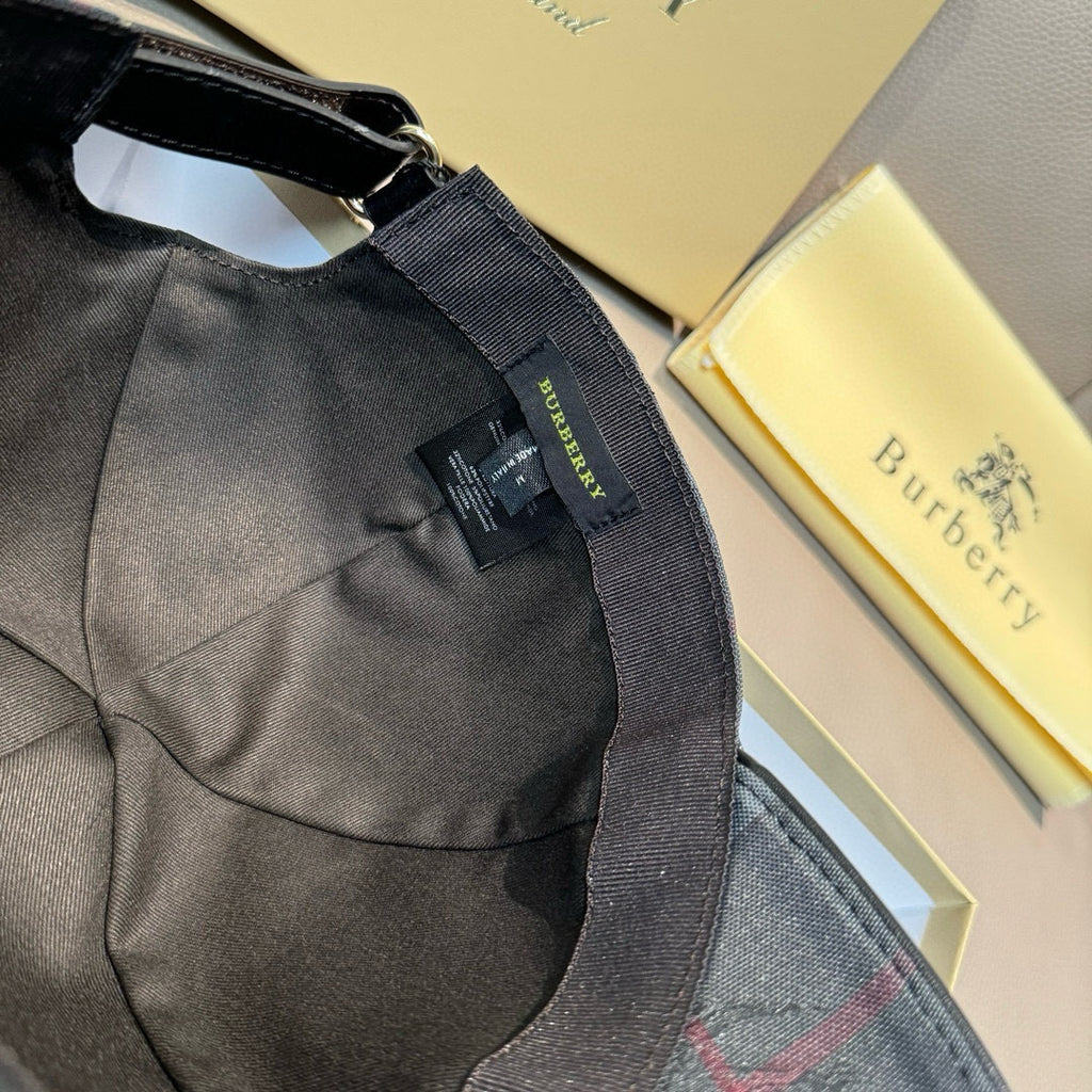 Black cap with fabric strap and swing tag, inside seam visible
