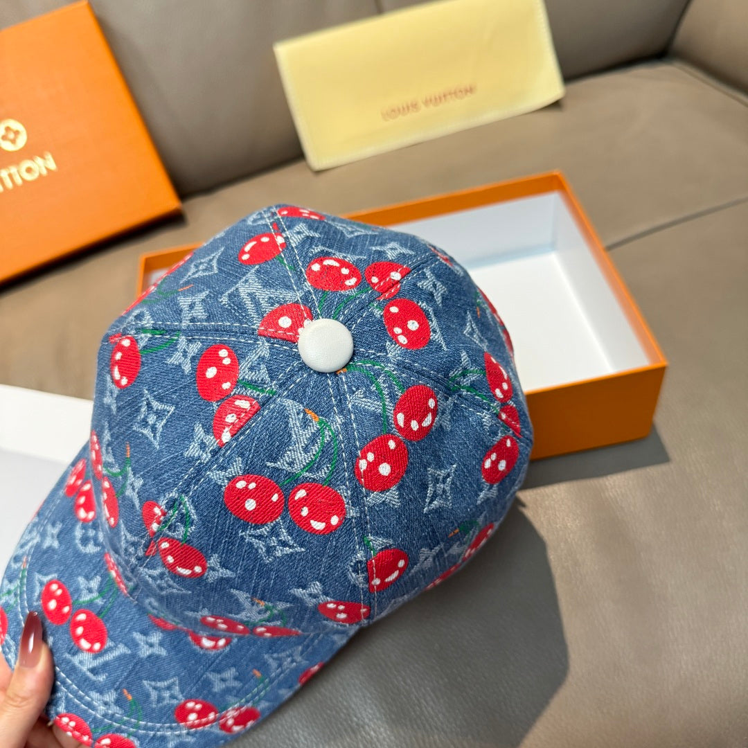 Blue denim cap with red mushroom print and light top button detail