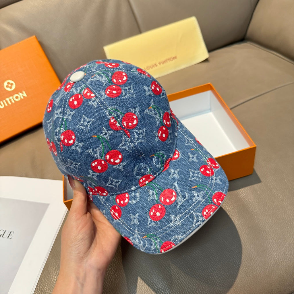 Blue denim cap with red mushroom pattern and light button detail at top