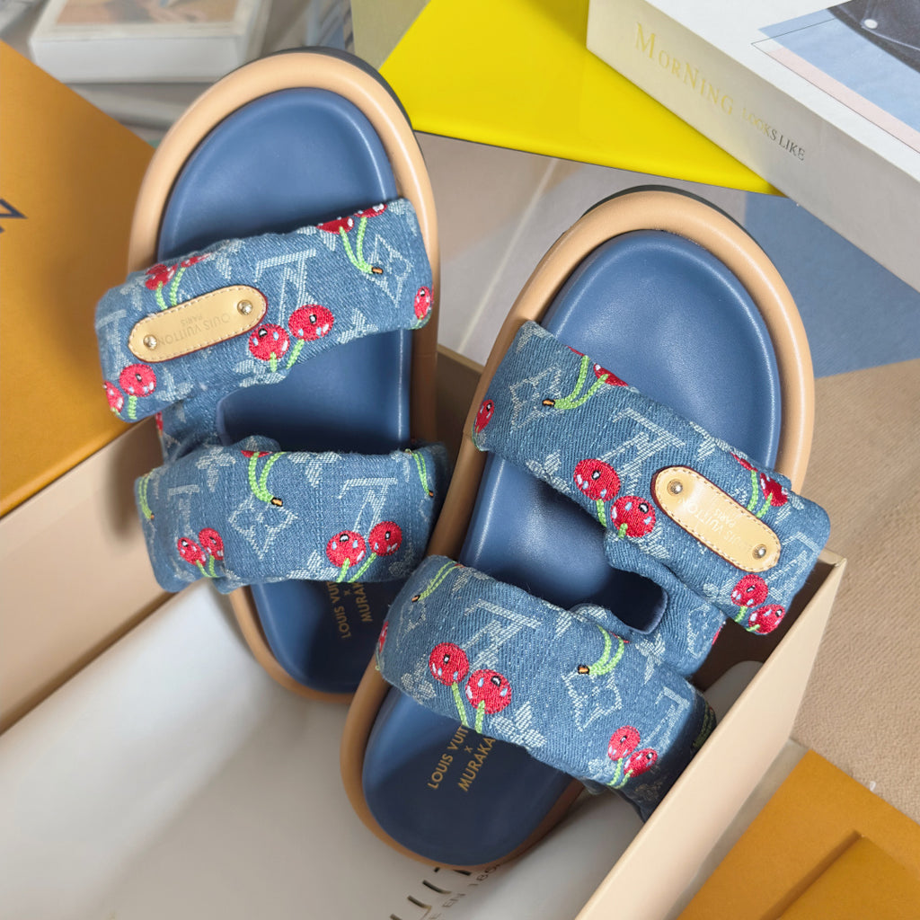 Blue Louis Vuitton slide sandals with tan strap accents and cherry print fabric