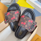 Louis Vuitton slide sandals close-up: dark monogram canvas with red cherries on the straps