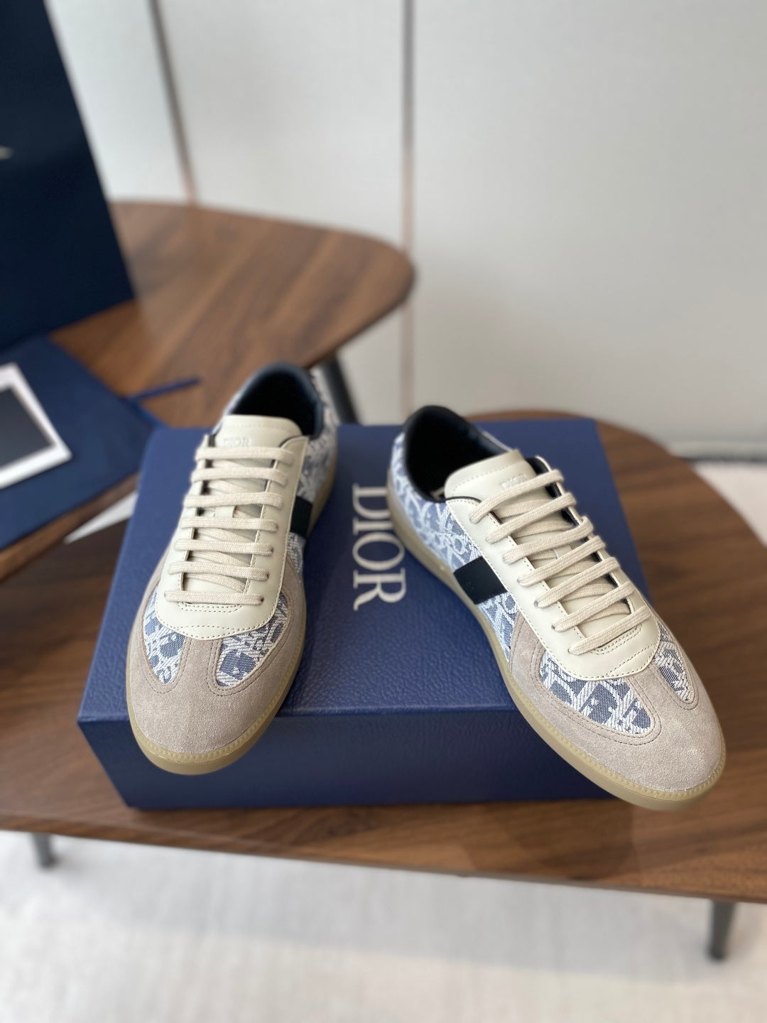 Dior sneakers with cream uppers and blue monogram panels, black side cutout