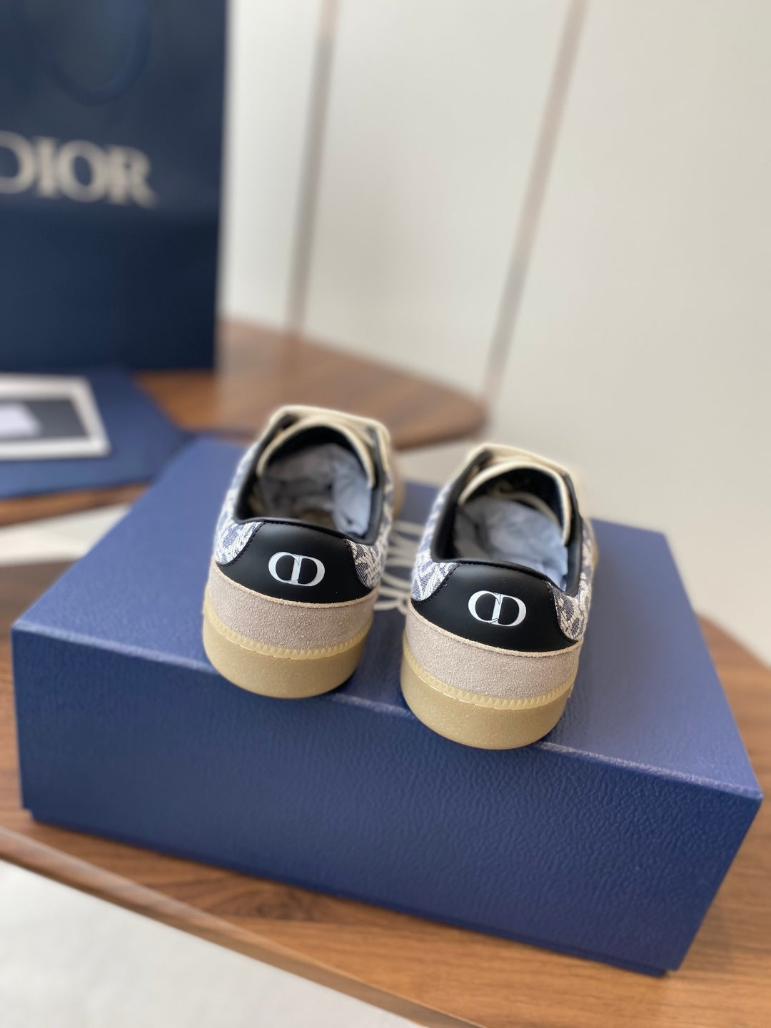 Dior sneakers from heel: cream uppers, blue monogram trim, cushioned back