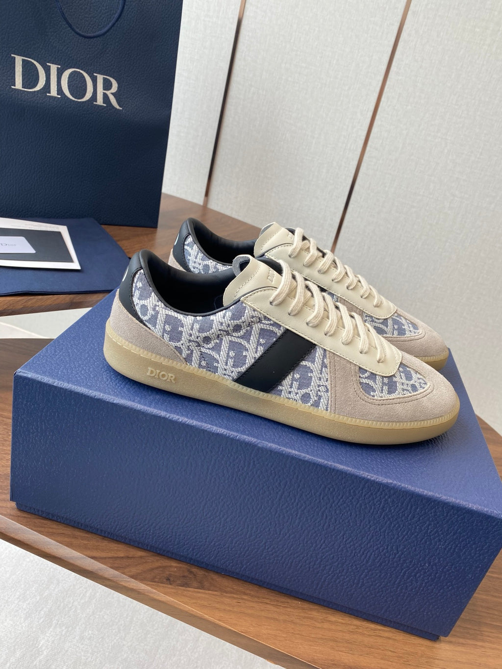 Dior sneakers with cream laces, blue monogram side stripe, black heel tab