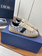 Dior sneakers with cream laces, blue monogram side stripe, black heel tab