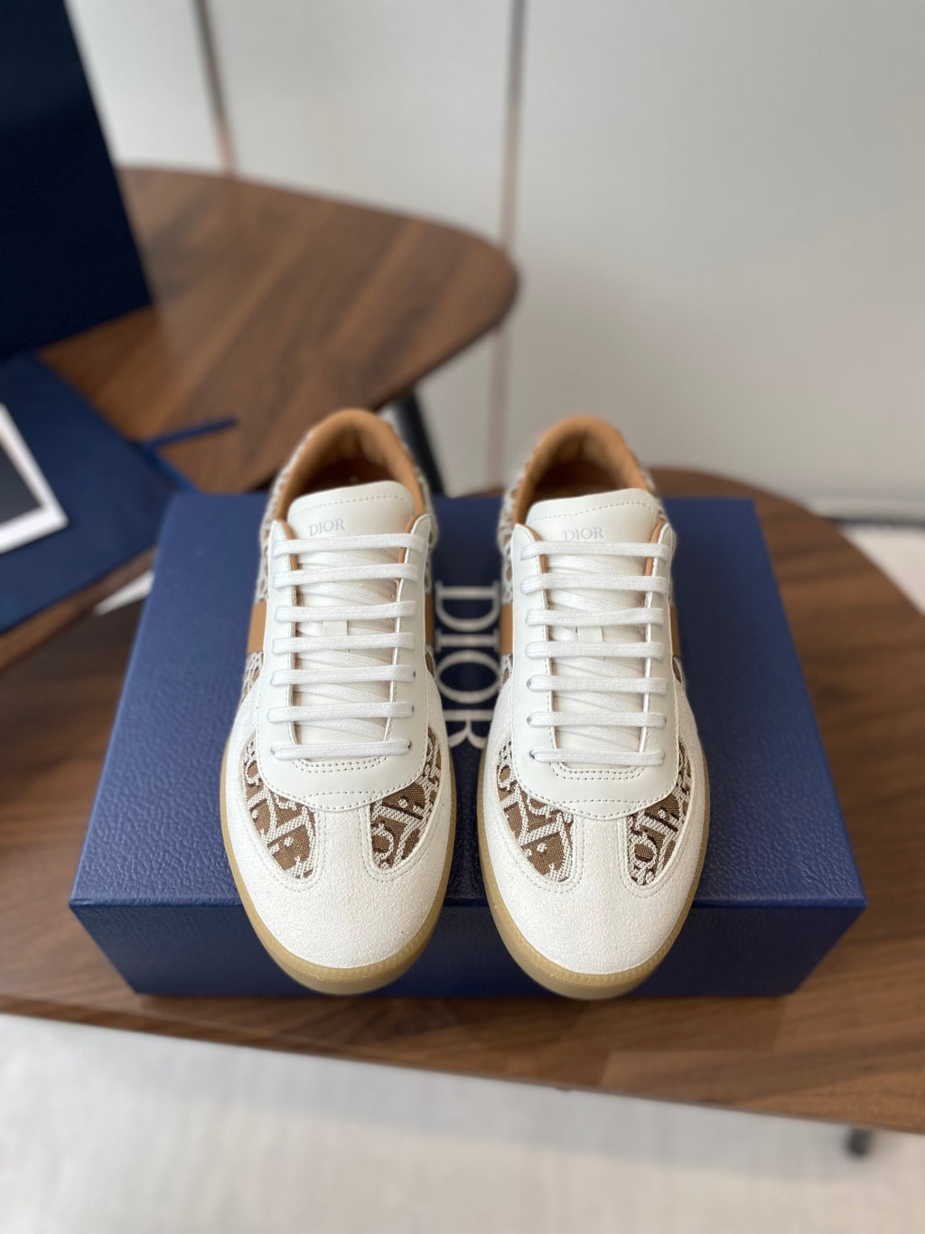 Pair of Dior unisex sneakers in white with tan monogram panel and white laces