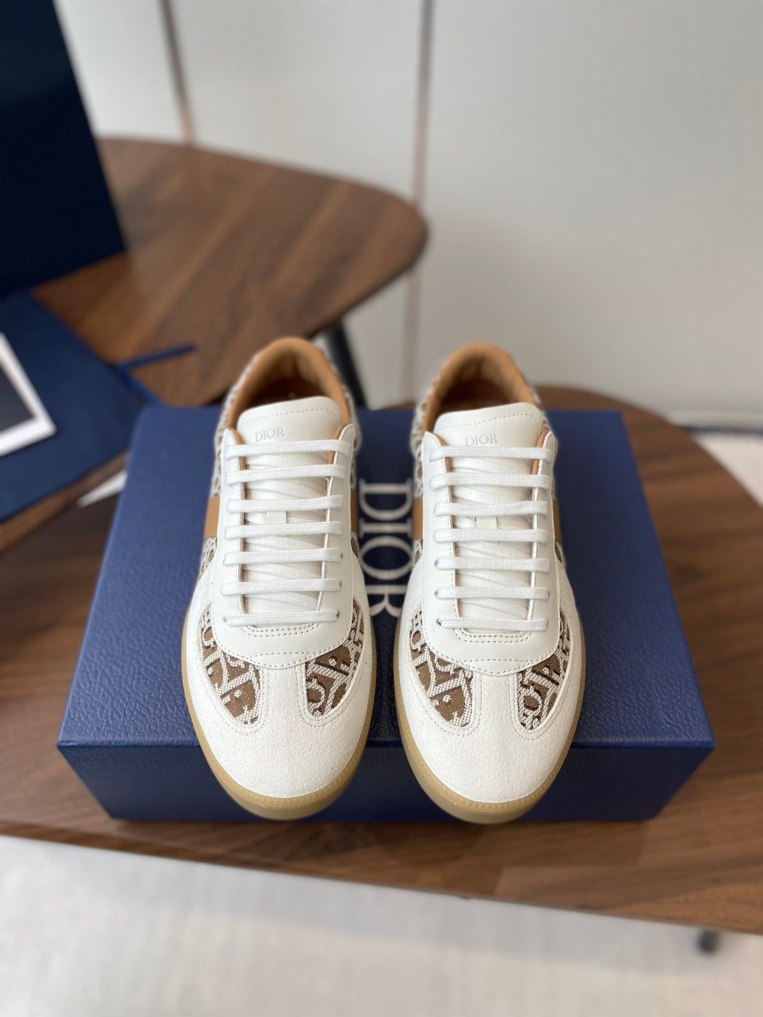 Pair of Dior unisex sneakers in white with tan monogram panel and white laces