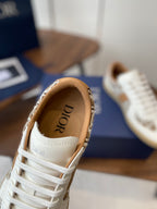 Dior unisex sneaker showing white tongue with DIOR logo patch and tan lining