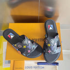 Louis Vuitton slide sandals with black straps and multicolor monogram flower print