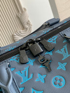 Blue monogram duffel bag close-up of zipper pull and engraved hardware