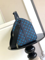 Blue monogram duffel bag with top handle and adjustable shoulder strap