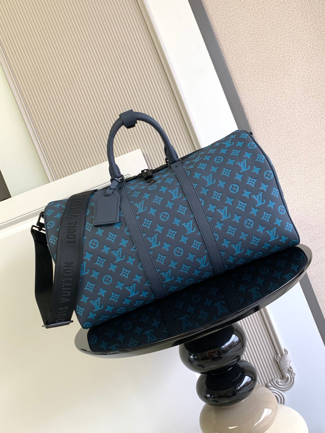 Louis Vuitton duffel bag in blue with monogram pattern, top handles and side strap