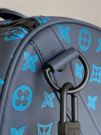 Blue monogram duffel bag close-up of D-ring handle attachment